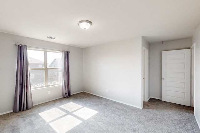 unfurnished bedroom featuring light carpet