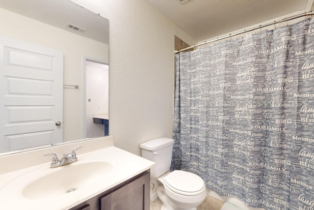 bathroom featuring vanity, curtained shower, and toilet