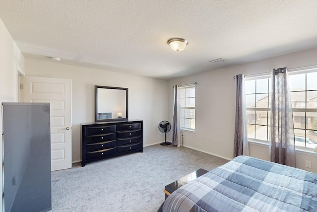 carpeted bedroom featuring a textured ceiling