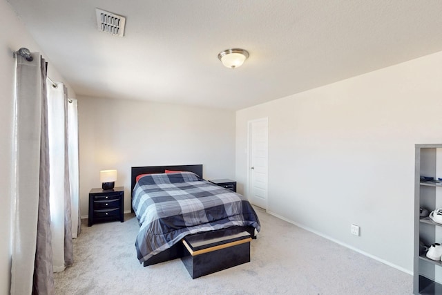 bedroom featuring light colored carpet