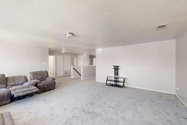 unfurnished living room with carpet flooring and a textured ceiling