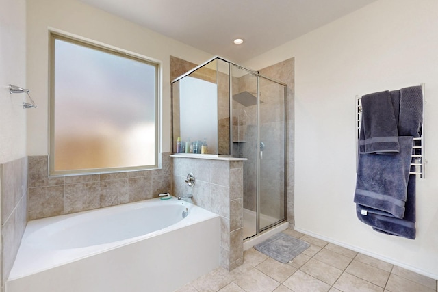 bathroom with separate shower and tub and tile patterned flooring