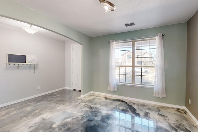 spare room with a textured ceiling