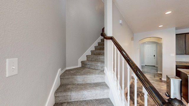 6217 Jackstaff Dr, Fort Worth, TX 76179 - stairway with arched walkways, baseboards, a textured wall, recessed lighting, and carpet