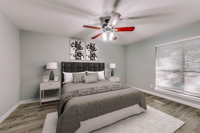 bedroom with ceiling fan and wood-type flooring