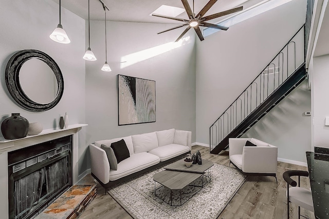 living room with hardwood / wood-style flooring, vaulted ceiling, and ceiling fan