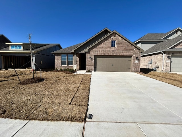 view of front facade with a garage, concrete driveway, and brick siding