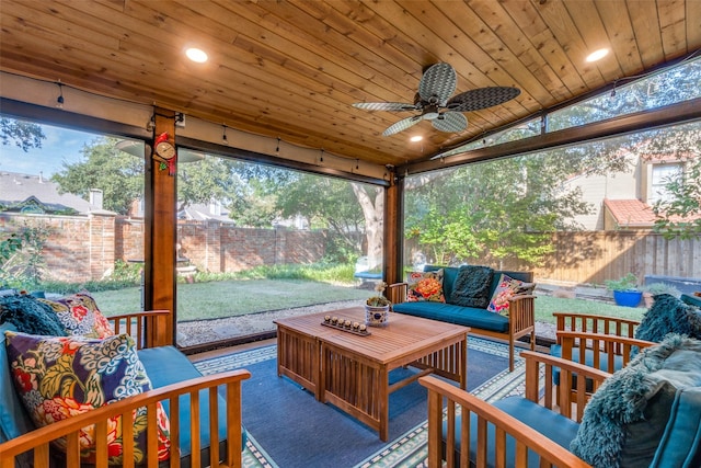 sunroom / solarium with ceiling fan, wood ceiling, and vaulted ceiling