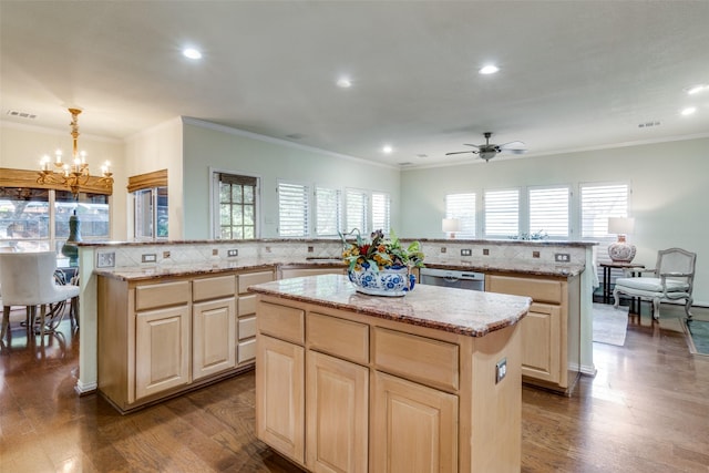 kitchen with pendant lighting, kitchen peninsula, and a kitchen island