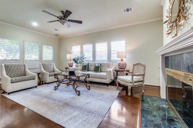 living room featuring crown molding, dark wood-type flooring, and ceiling fan