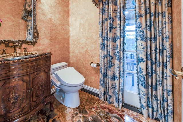 bathroom featuring vanity and toilet