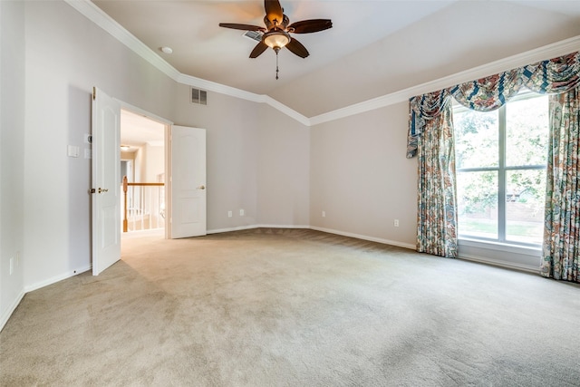 unfurnished room featuring crown molding, light colored carpet, ceiling fan, and vaulted ceiling