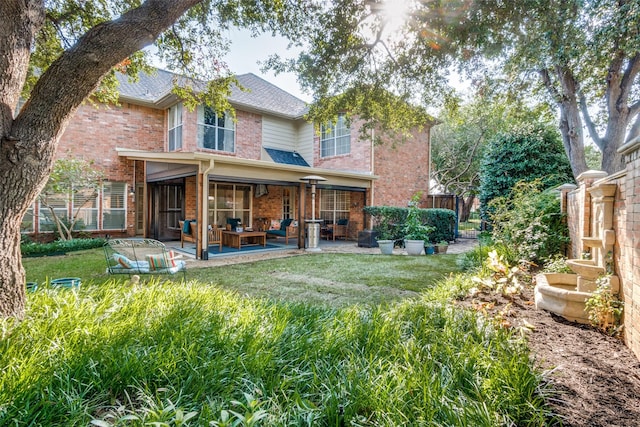 back of house featuring a yard and a patio area