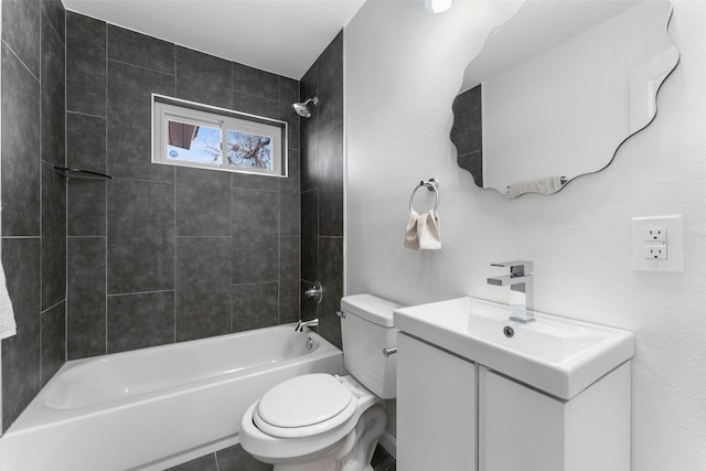 full bathroom with tile patterned floors, tiled shower / bath combo, vanity, and toilet