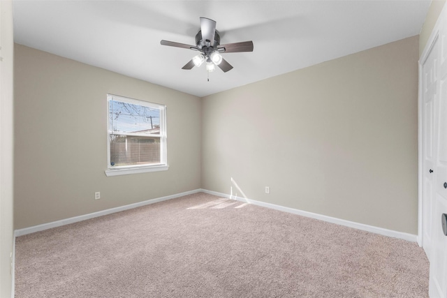 carpeted empty room featuring ceiling fan