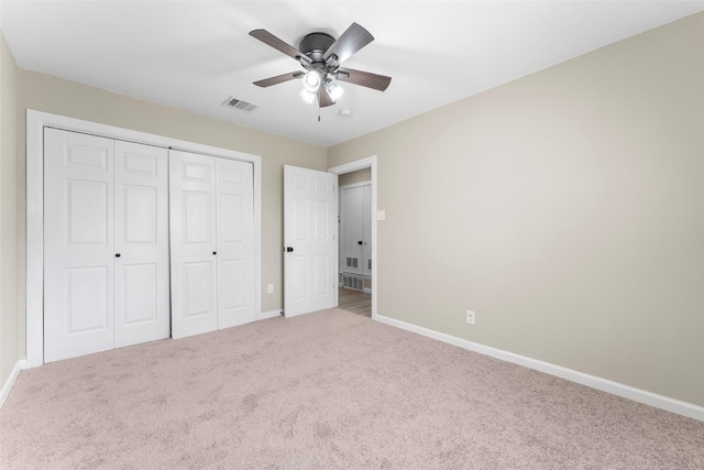 unfurnished bedroom with ceiling fan, carpet, and a closet