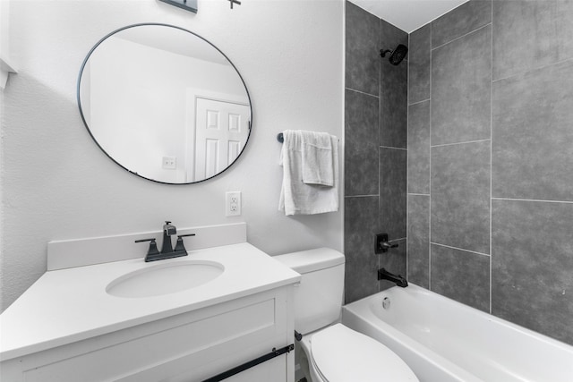 full bathroom with toilet, vanity, and tiled shower / bath