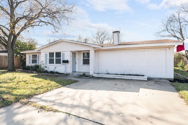 ranch-style house featuring a front yard and a garage