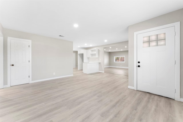 unfurnished living room featuring light wood-type flooring