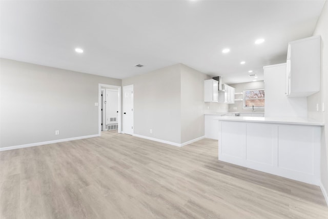 unfurnished living room with light hardwood / wood-style floors