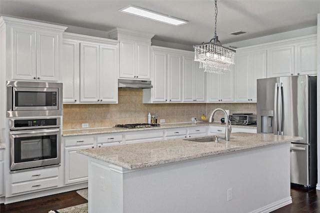 kitchen featuring a kitchen island with sink, sink, white cabinets, and appliances with stainless steel finishes