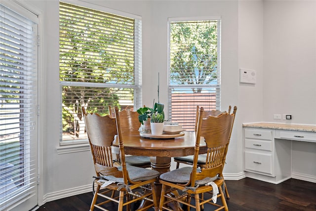 dining space with dark hardwood / wood-style flooring