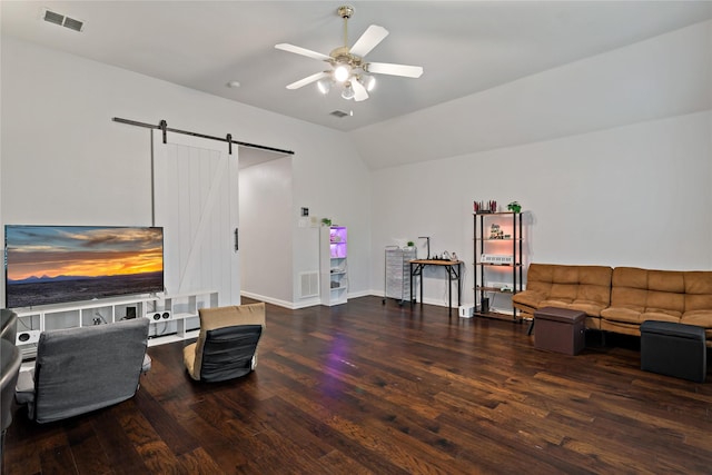 living area with vaulted ceiling, ceiling fan, a barn door, and dark hardwood / wood-style flooring