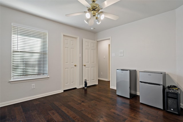 interior space featuring dark wood-type flooring and ceiling fan