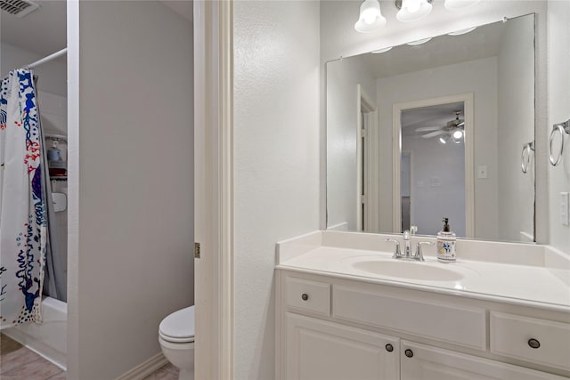 full bathroom with vanity, ceiling fan, shower / bath combination with curtain, and toilet