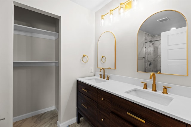 bathroom featuring a shower and vanity