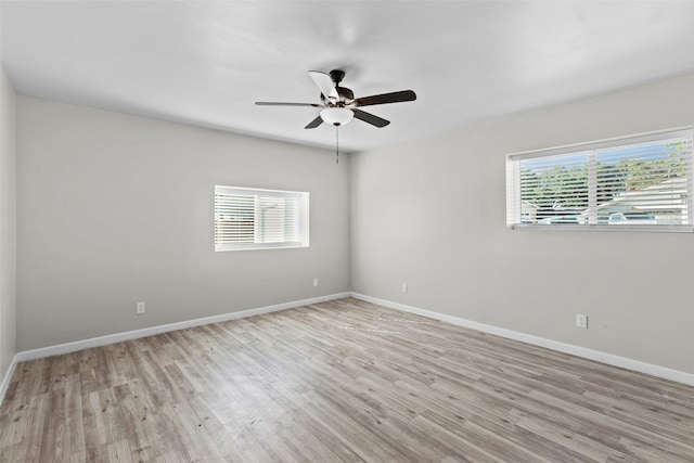 unfurnished room with ceiling fan, plenty of natural light, and light hardwood / wood-style flooring