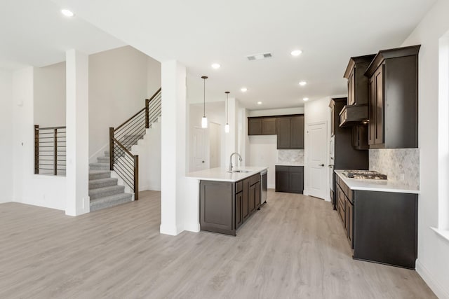 1217 Sylvia St, Desoto, TX 75115 - kitchen with a sink, light wood finished floors, dark brown cabinets, light countertops, and recessed lighting