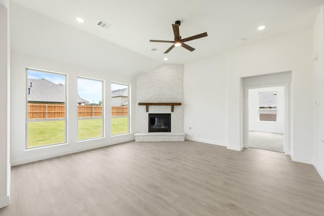 1217 Sylvia St, Desoto, TX 75115 - unfurnished living room with ceiling fan, healthy amount of natural light, light wood-type flooring, a large fireplace, and vaulted ceiling