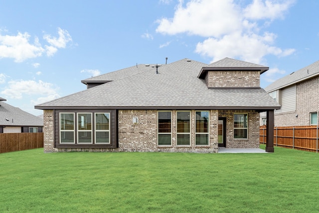 1217 Sylvia St, Desoto, TX 75115 - back of house with a shingled roof, brick siding, and a patio