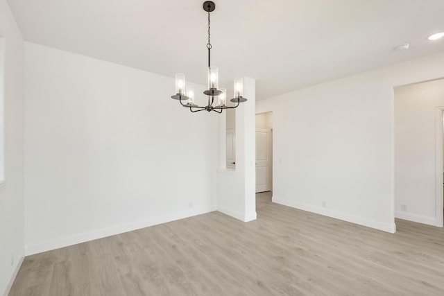 1217 Sylvia St, Desoto, TX 75115 - unfurnished room with a chandelier, light wood-style flooring, and baseboards