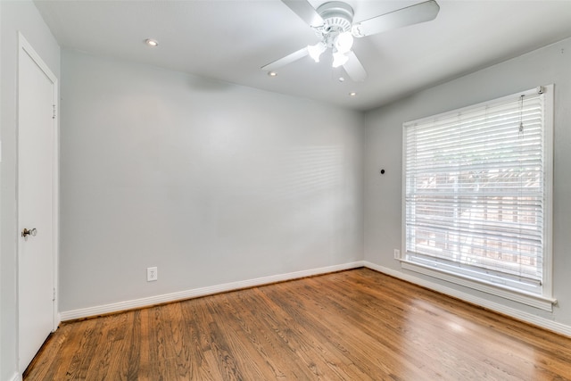 unfurnished room with ceiling fan, a healthy amount of sunlight, and hardwood / wood-style floors