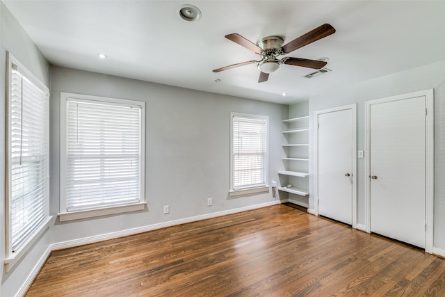 unfurnished bedroom with ceiling fan and dark hardwood / wood-style floors