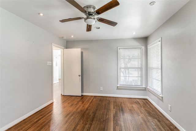 spare room featuring ceiling fan and dark hardwood / wood-style floors