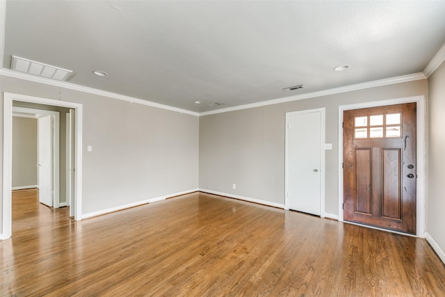 entryway with crown molding and wood-type flooring