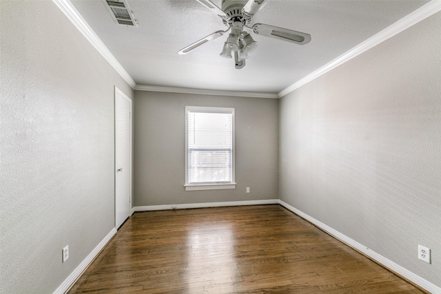 spare room with ceiling fan, dark hardwood / wood-style flooring, and ornamental molding