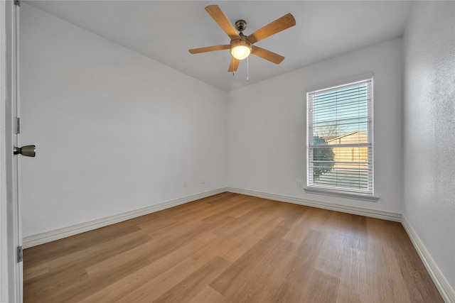 spare room with ceiling fan and light wood-type flooring