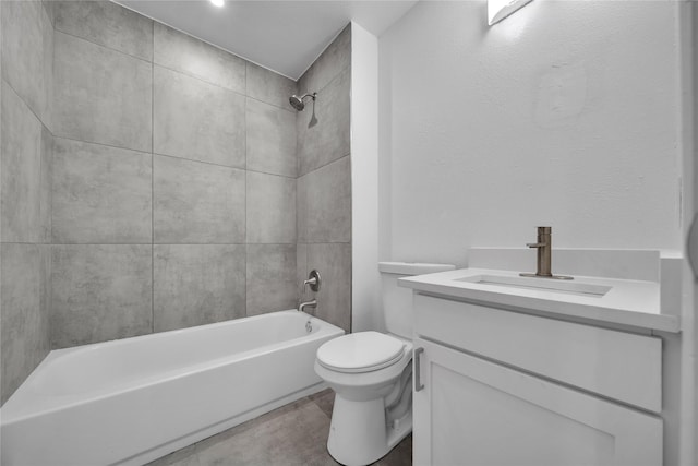 full bathroom featuring toilet, vanity, and tiled shower / bath