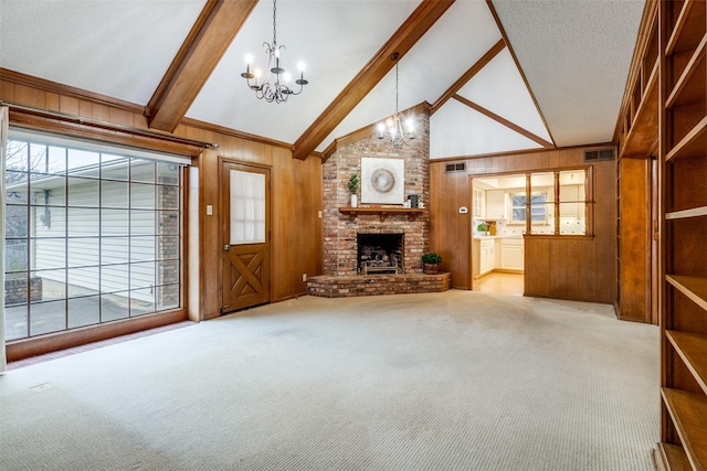 unfurnished living room with beamed ceiling, light carpet, a chandelier, and wood walls