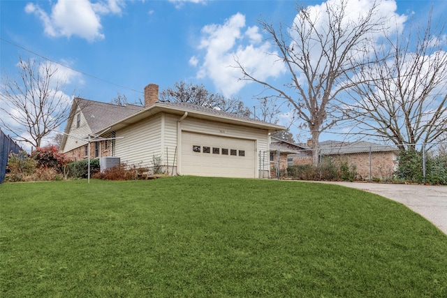 view of side of home featuring a yard, a garage, and central AC