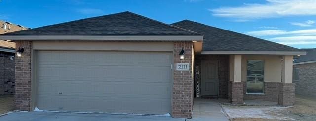 ranch-style home featuring a garage