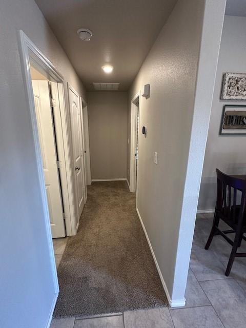 hallway with light tile patterned floors