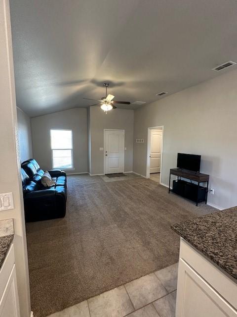 living room featuring light carpet, ceiling fan, and lofted ceiling