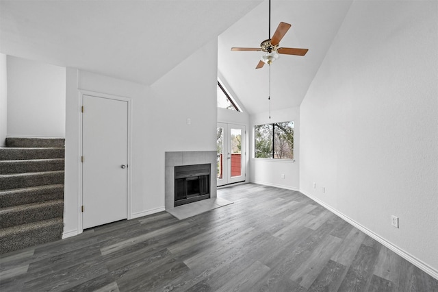 unfurnished living room featuring ceiling fan, dark hardwood / wood-style flooring, french doors, and high vaulted ceiling