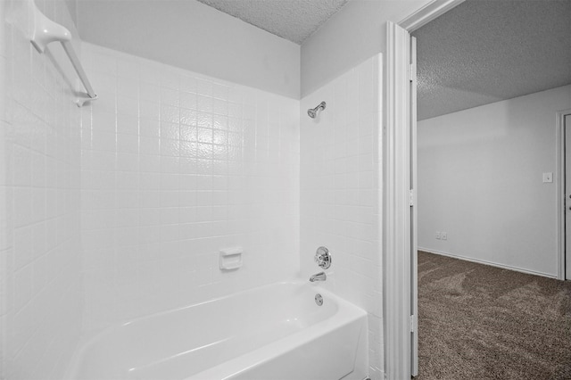 bathroom with a textured ceiling and washtub / shower combination