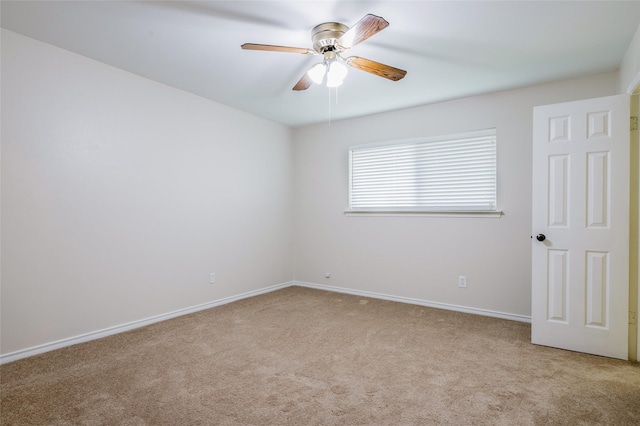 carpeted spare room with ceiling fan